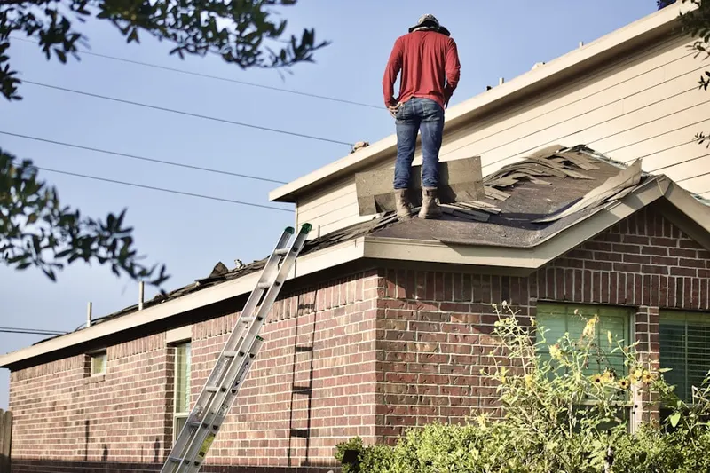 Professional roofer working on a residential roof in Tariffville Center